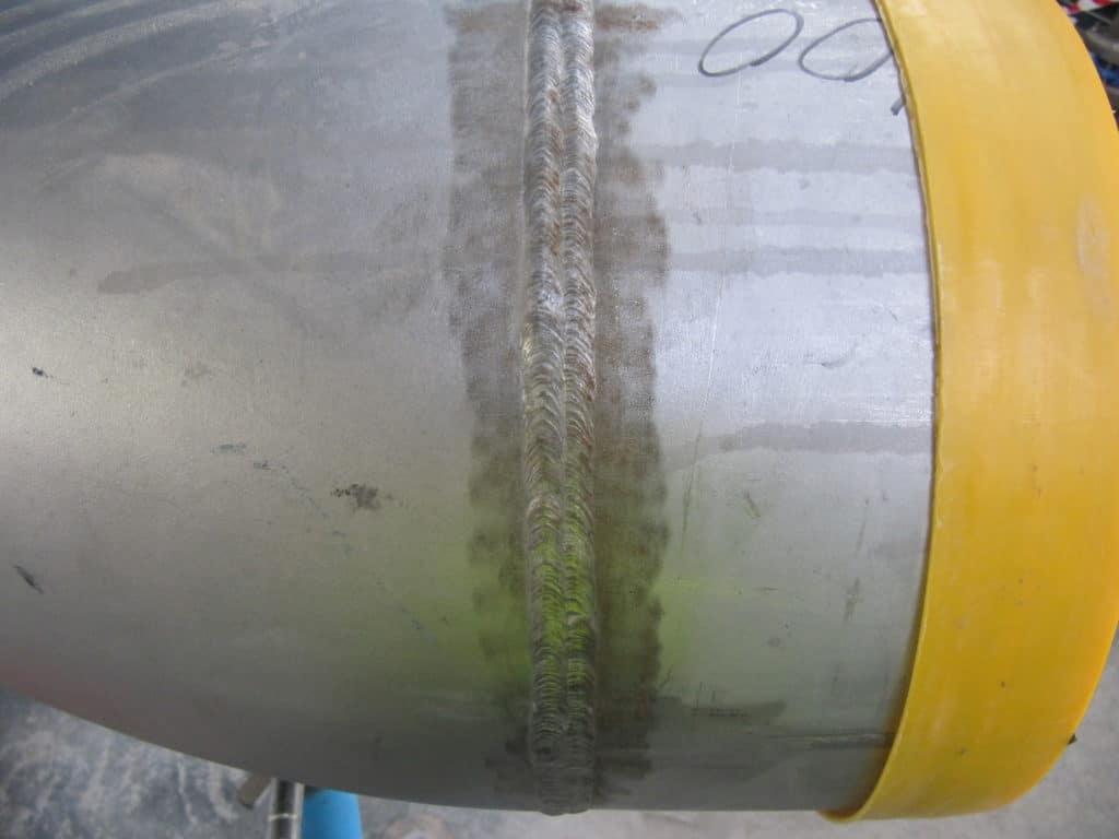 Rusted weld join on stainless steel metal