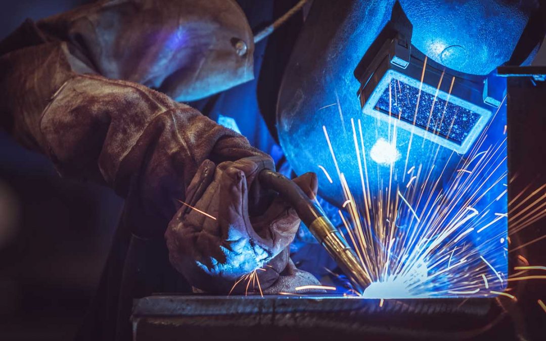 Industrial Worker labourer at the factory welding steel structure. Welding History